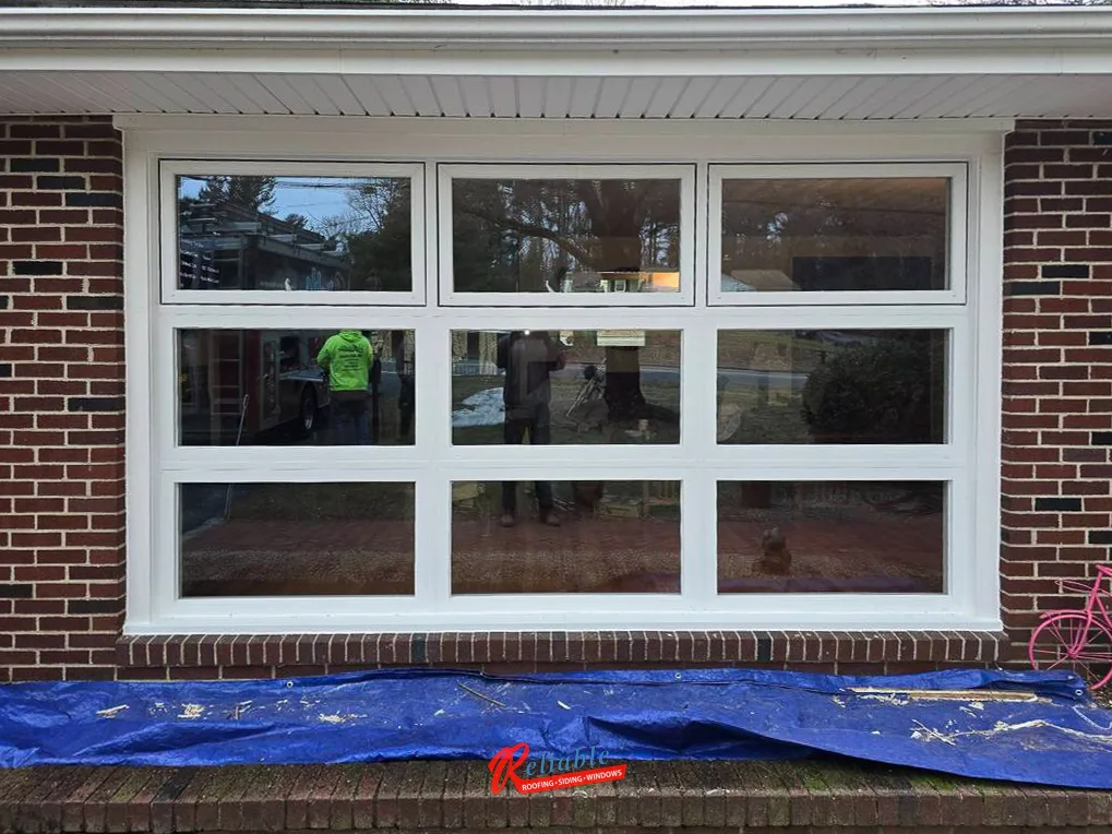New white picture window installed in a brick home in Sharon, Massachusetts